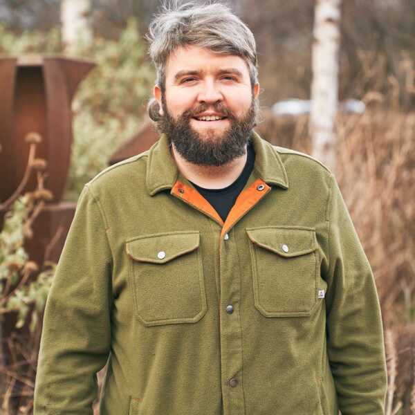 Man smiling stood outside