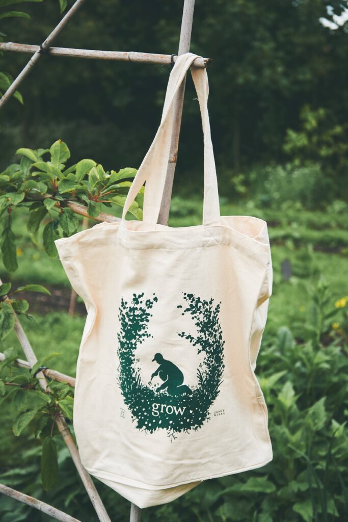 Grow tote bag hanging in a garden