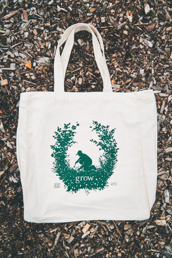 Grow tote bag against a wood chip background
