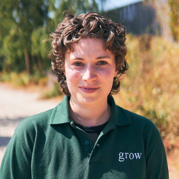 Woman in green polo shirt stood outside