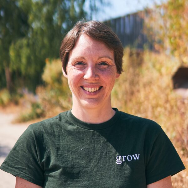 Woman in dark green tshirt stood outside